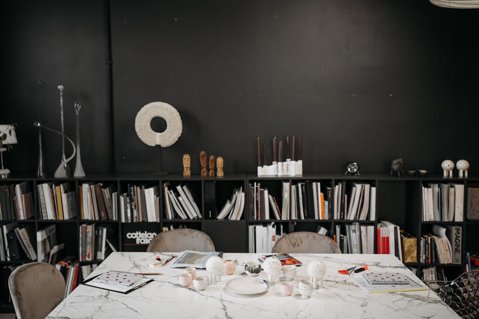 Elegant conference room featuring a marble table, black bookshelves, and stylish decor elements.
