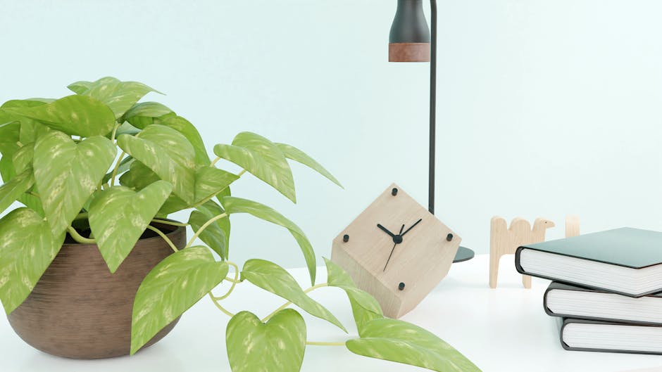 A stylish desktop with a clock, plant, and books, perfect for a minimalist and modern aesthetic.